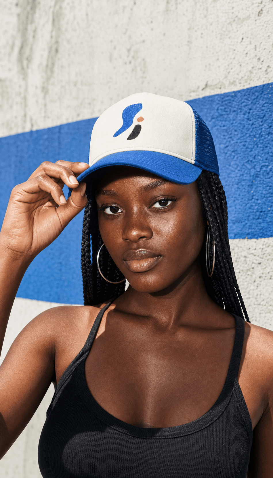Demo model wearing a cream and cobalt custom trucker cap