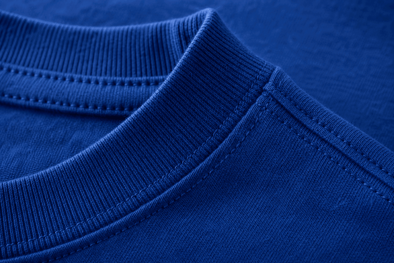 Macro detail of a cobalt heavyweight T-shirt collar and stitching