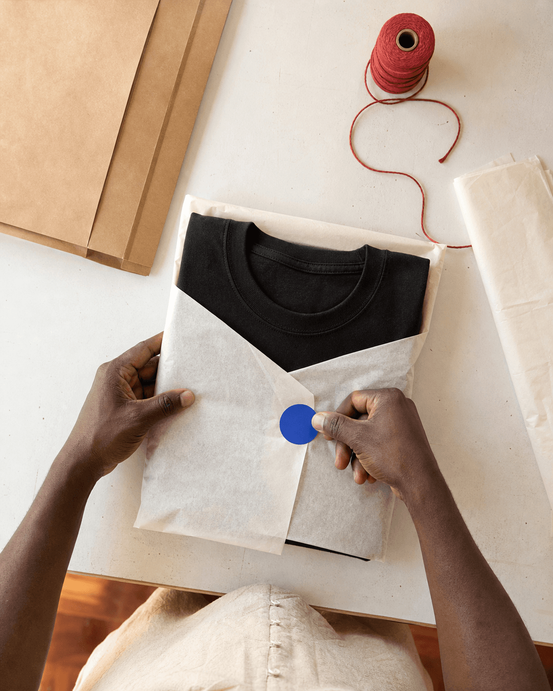 Demo packaging process for a folded black T-shirt
