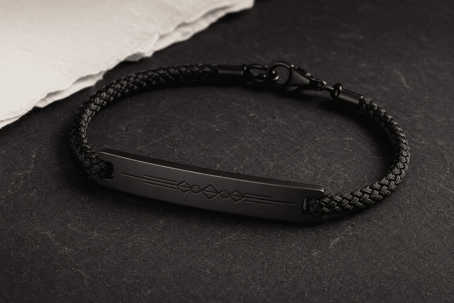 Matte-black engraved bar bracelet with braided cord